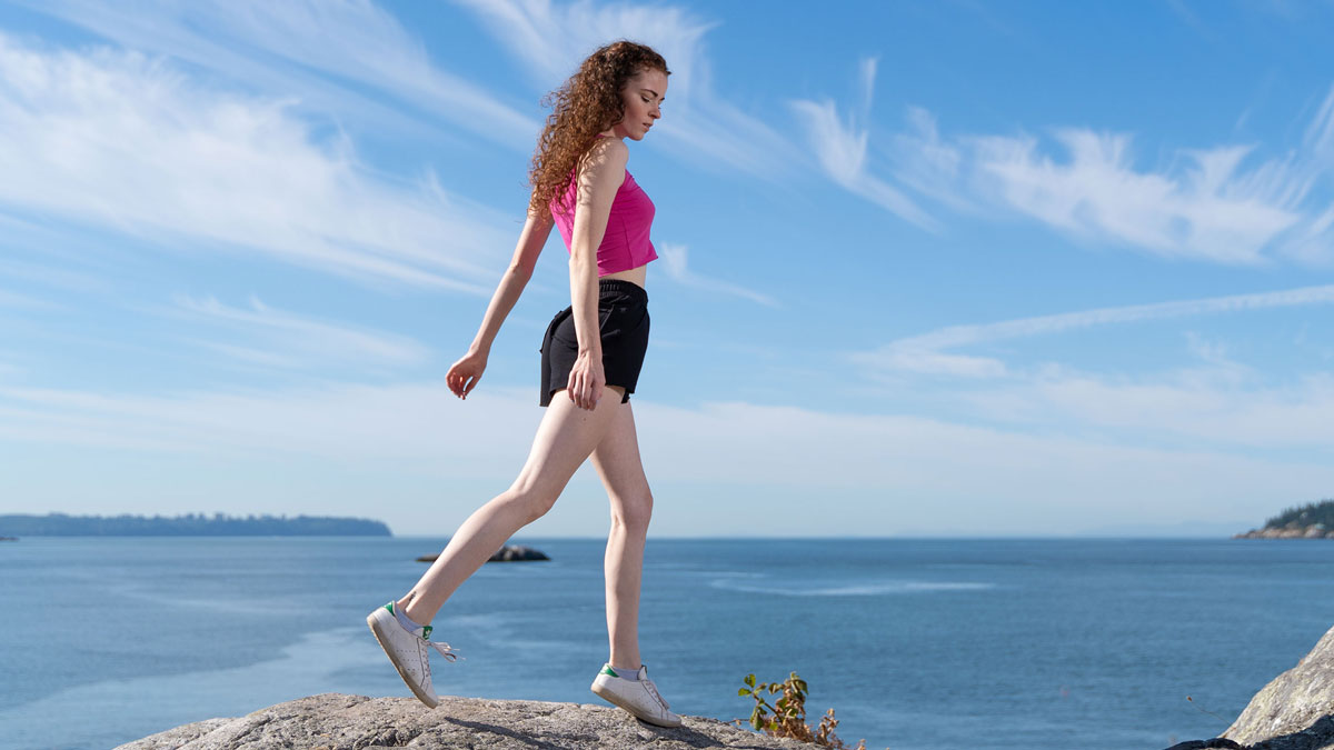 A women hiking in an Bamboo Tank Top and Organic Cotton Shorts
